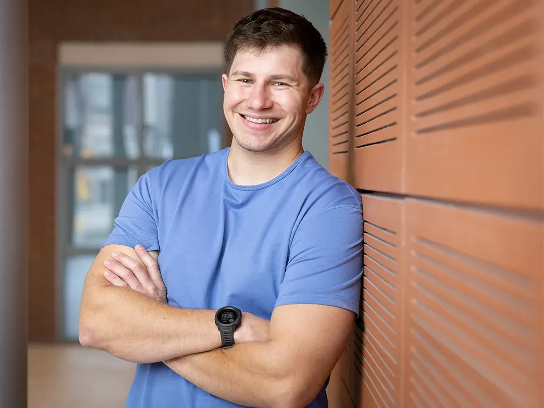 Ryan Marquette sitting at a desk smiling.